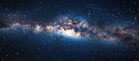 Naklejka premium Expansive dark blue night sky featuring a vibrant starry backdrop with a luminous galaxy extending diagonally from the left to right center.
