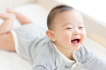 Happy baby playing on bed