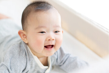 Happy baby playing on bed