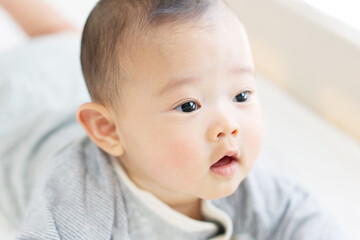 Happy baby playing on bed