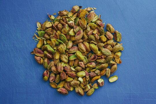View from above pile of freshly shelled pistachio nuts
