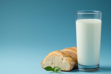 Organic milk from local farms ,support for local agriculture. Glass of milk with fresh bread on a blue background.