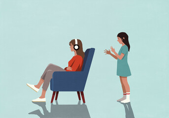 Girl gesturing, talking to oblivious mother sitting in armchair with headphones
