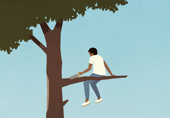 Teenage boy with saw cutting tree branch he is sitting on
