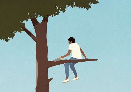 Teenage boy with saw cutting tree branch he is sitting on
