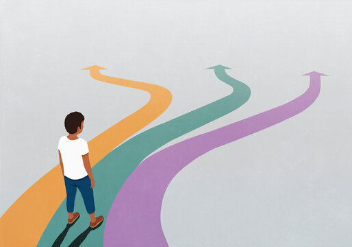 Man looking down at three multicolored arrow paths spreading before him
