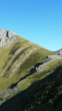 Majestic mount txindoki rises against a clear blue sky in the basque country, showcasing its rugged beauty and serene landscape