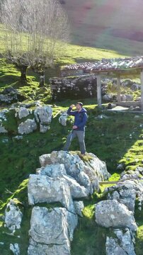 Picturesque journey of a hiker exploring the rocky terrain and scenic landscapes of mount txindoki in gipuzkoa, basque country