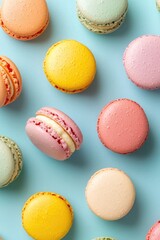 Obraz premium Colorful macaroons on a pastel background. Top view