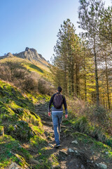 Fototapeta premium Hiker walking up mount txindoki in the basque country, spain