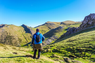 Hiker embracing the majestic view of mount txindoki in the basque country