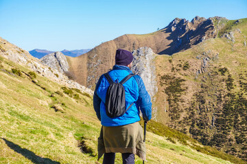 Hiker contemplating breathtaking view of mount txindoki in the basque country