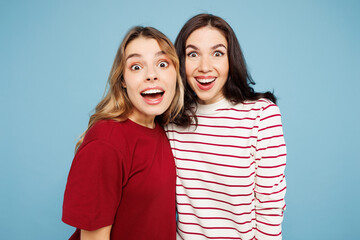 Obraz premium Young shocked surprised amazed excited couple two friends women wear red casual clothes hug look camera together isolated on pastel plain light blue cyan background studio portrait. Lifestyle concept.