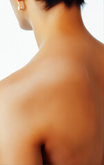 Naklejka premium Minimalist close-up of a woman’s back and neck with smooth skin against a neutral background