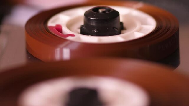 macro vintage audio cassette in tape recorder plays or records music composition, cassette audio tape recorder close-up