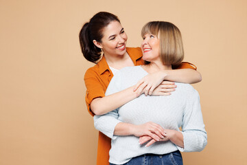 Elder cheerful parent mom 50s years old with young adult daughter two women together wear casual...