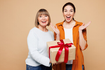 Elder surprised parent mom 50s years old with young daughter two women together wear casual clothes...