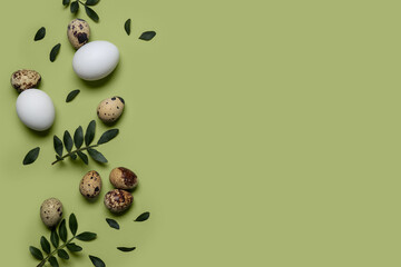 Easter eggs with leaves on green background
