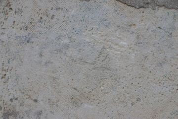 Textured surface of unfinished concrete in Albania showcasing distinct marks and patterns caused by construction activity