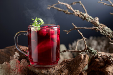 Hot drink with cranberries, lime, and rosemary.
