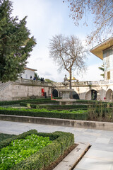 Garden of Topkapi Palace in Istanbul with an ancient fountain