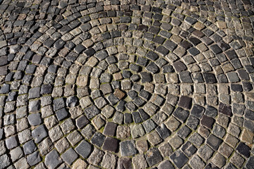 Elegant cobblestone circular pattern in a historic town square exhibiting craftsmanship and timeless beauty