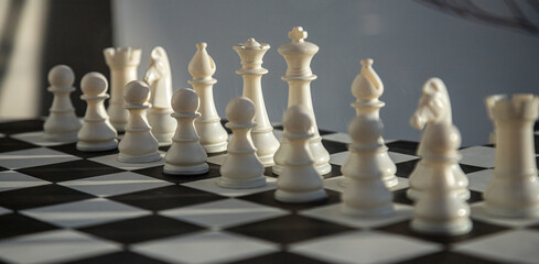 Chess pieces arranged on a checkered board in Bucharest, Romania during a quiet afternoon