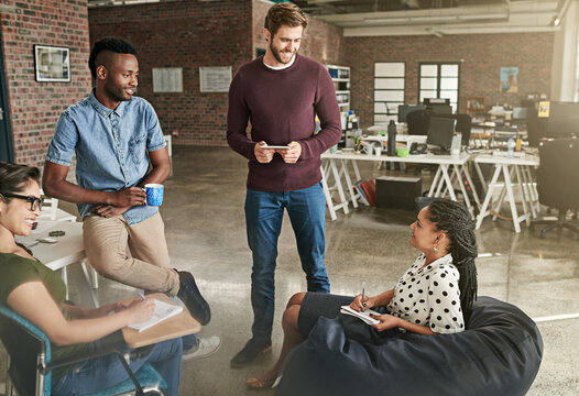 Creative, business people and meeting with team in lounge for brainstorming, ideas or collaboration at office suite. Group, employees or designers with smile for project planning or staff discussion