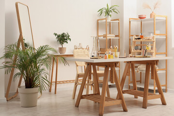 Interior of makeup room with dressing table, mirror and shelf units