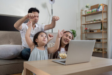 Excited family dancing and enjoying a fun moment together