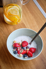 Rice pudding with milk decorated berries and seeds.