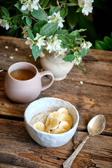 Oatmeal with banana. wooden background, side view