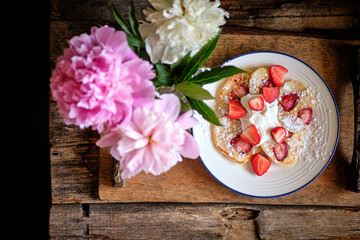 pancakes with strawberries. Wooden background, top view.