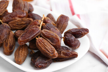 Tasty dried dates on white table, closeup