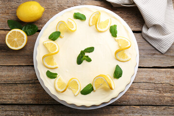 Delicious lemon cheesecake with mint and fresh fruits on wooden table, flat lay