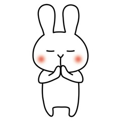 手を合わせて願い事をする白いうさぎ