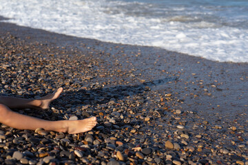 Relaxing by the pebble beach shoreline