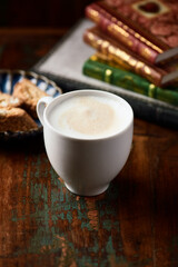 Cappuccino on dark wooden background. Soft focus. Close up.