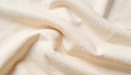 Fototapeta premium Soft beige fabric with gentle folds and texture. Eco-friendly clothing, Linen shirt, Bamboo fiber clothing, Recycled fabric, Zero waste fashion, Second hand, Biodegradable fabrics