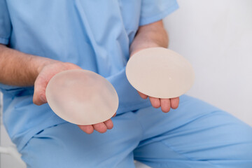 doctor holding breast enlargement implant in hands, plastic surgery concept, beauty enhancement, medical Mammoplasty and plastic surgery, mastopexy