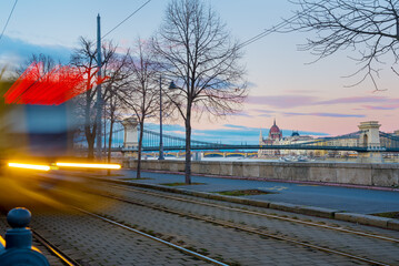 Tram in motion against Budapest landmarks