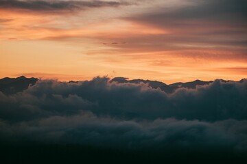 Sunset Over Mountain Peaks with Clouds