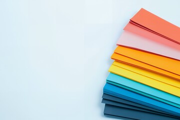 Vibrant Rainbow Colored Paper Sheets Stacked High on White Background for Design Projects
