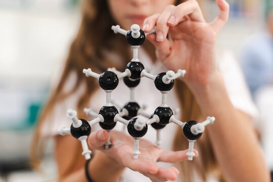 Close up of student hold science molecular model, chemistry molecular structure in school laboratory. Student with molecular model in science chemistry class. Chemistry model in science class