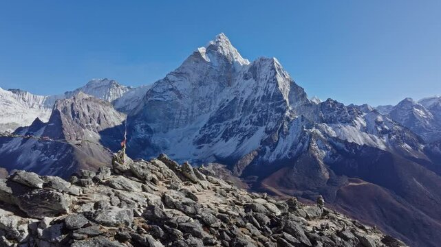 Sunlight illuminates impressive Mount Everest in the Himalayas of eastern Nepal, showcasing its snow capped beauty and rocky terrain