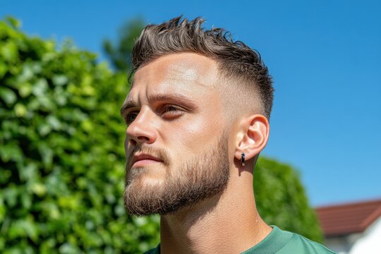 Discover the epitome of contemporary men's style with this striking image showcasing a sharp-looking man with sleek haircut, a paragon of fresh and modern aesthetics Explore the nuances of beard