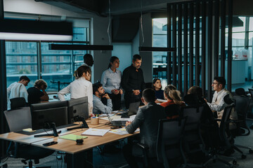 Diverse team of business people is seen collaborating in a modern office. They engage in...
