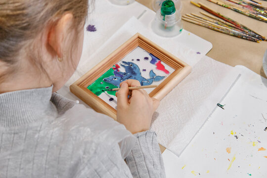 Childs hands coloring in stained glass painting technique picture