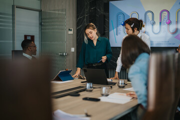 A diverse group of people engaged in a productive meeting in a contemporary office. The team is...