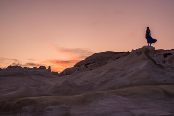 Woman in blue dress at Sarakiniko, island of Milos, Greece